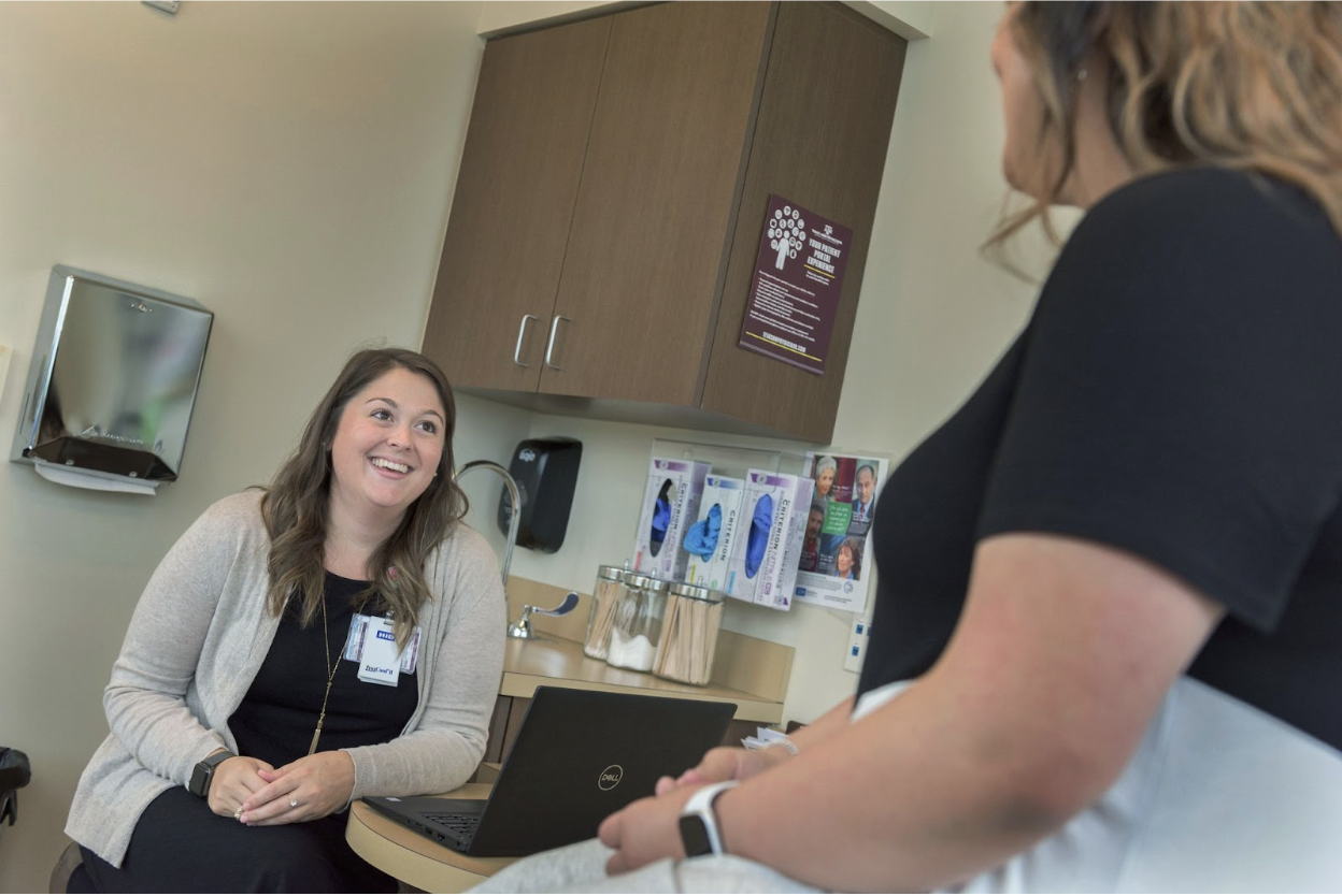 Two people talking in a clinic room. 