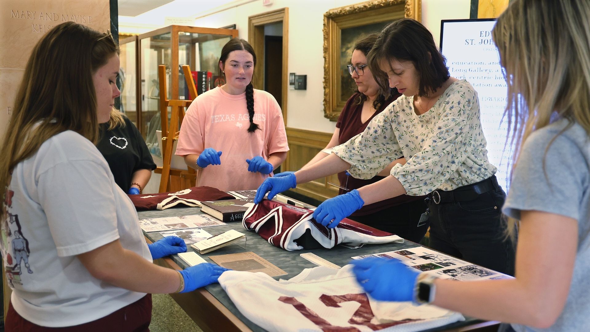 Students work with Cushing staff to set-up exhibit display case
