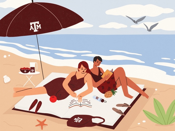 Two people reading on a beach