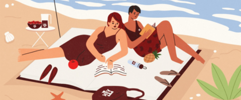 Two people reading on the beach 